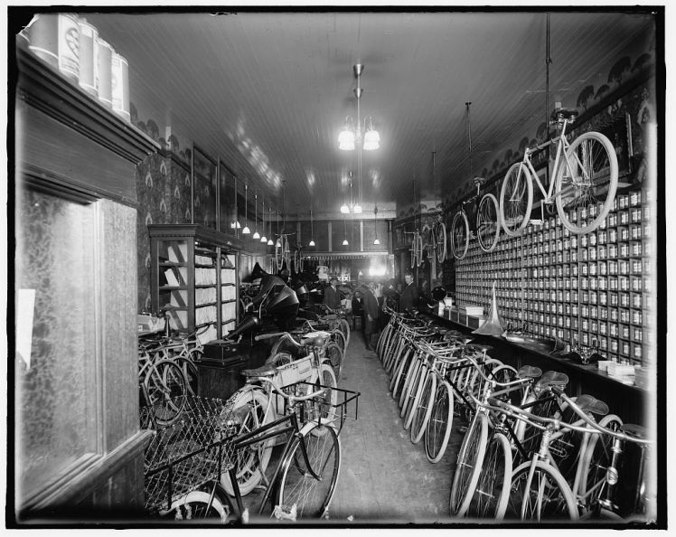 Interior of bike shop, possibly Huber & Metzger Bike Shop on Grand River between Woodward & Griswold.  Photo c. 1900-1920, Detroit Publishing Company. 